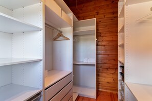 A walk-in closet with open shelves, a hanging rod, and a wooden ceiling. - Holiday Villa 'Tanqueta' with Mountain Views, Wi-Fi, and Air Conditioning (Santa Brigida)