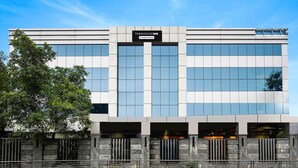 A modern building with a sign reading "Townhouse Oak." It features a symmetrical facade with large windows and a stone base. - Luxury Urban Stays Near Chennai Airport (Chennai)