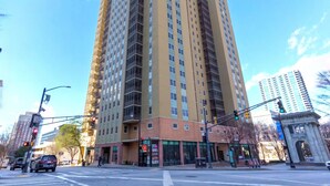 A tall, multi-story building with a beige facade and numerous windows.
