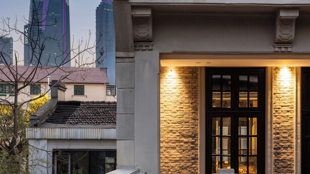 A traditional building with a tiled roof and a stone facade, featuring a balcony with a railing. - Blossom Manoir Lujiazui (Shanghai)