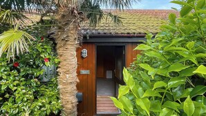 A wooden building with a sign reading "The Hut Hotel." - 3 bedroom accommodation in Portscatho (Portscatho)