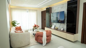 A modern living room with a sofa, armchair, and a coffee table.