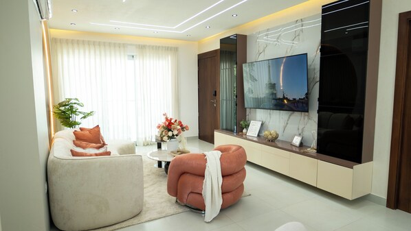 A modern living room with a sofa, armchair, and a coffee table.