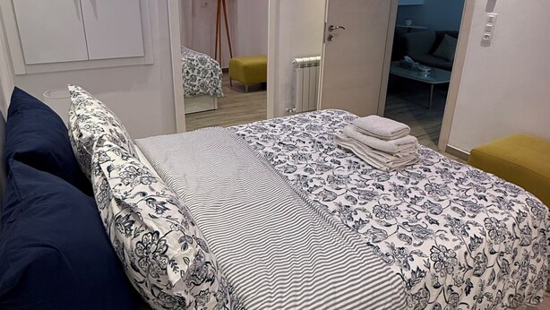 A modern bedroom with a bed, bedside tables, and a wardrobe. - Chic Luxury Appartement In The Heart Of La Marsa _ Walk to the Beach and Cafés (Marsa)