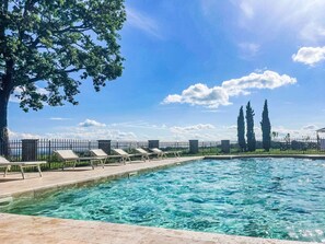 A swimming pool with clear blue water, surrounded by a tiled deck and lounge chairs. - La Bordona by Interhome (Vignale Monferrato)
