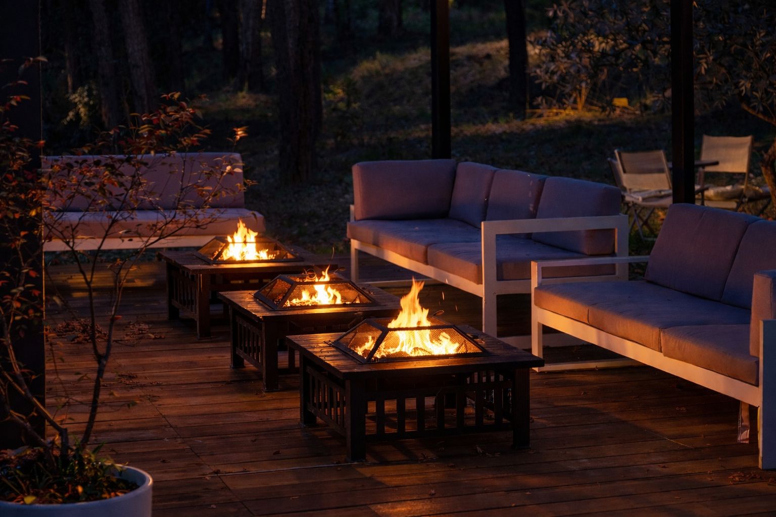 A deck with outdoor seating and fire pits.