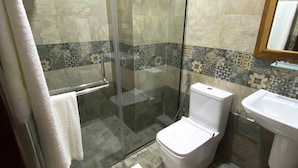 A modern bathroom with a glass-enclosed shower, a toilet, and a sink. - Manthra Leisure (Kandy)