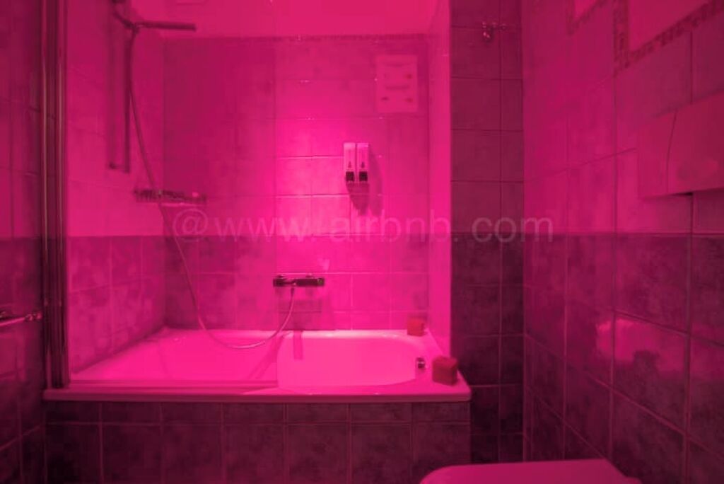 A bathroom with a shower, a bathtub, and a toilet.