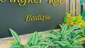A sign for 'Angkor Rise Boutique' with decorative lettering. - Angkor Rise Boutique (Siem Reap)