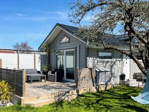 A modern house with a patio, outdoor furniture, and a swing. - 4 Star Holiday Home in Karlskrona (Hasslö)