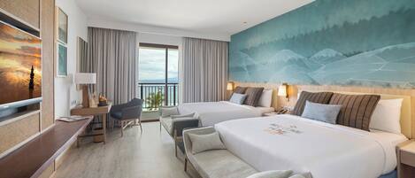 A hotel room with two beds, a desk, a chair, a TV, and a large painting on the wall.