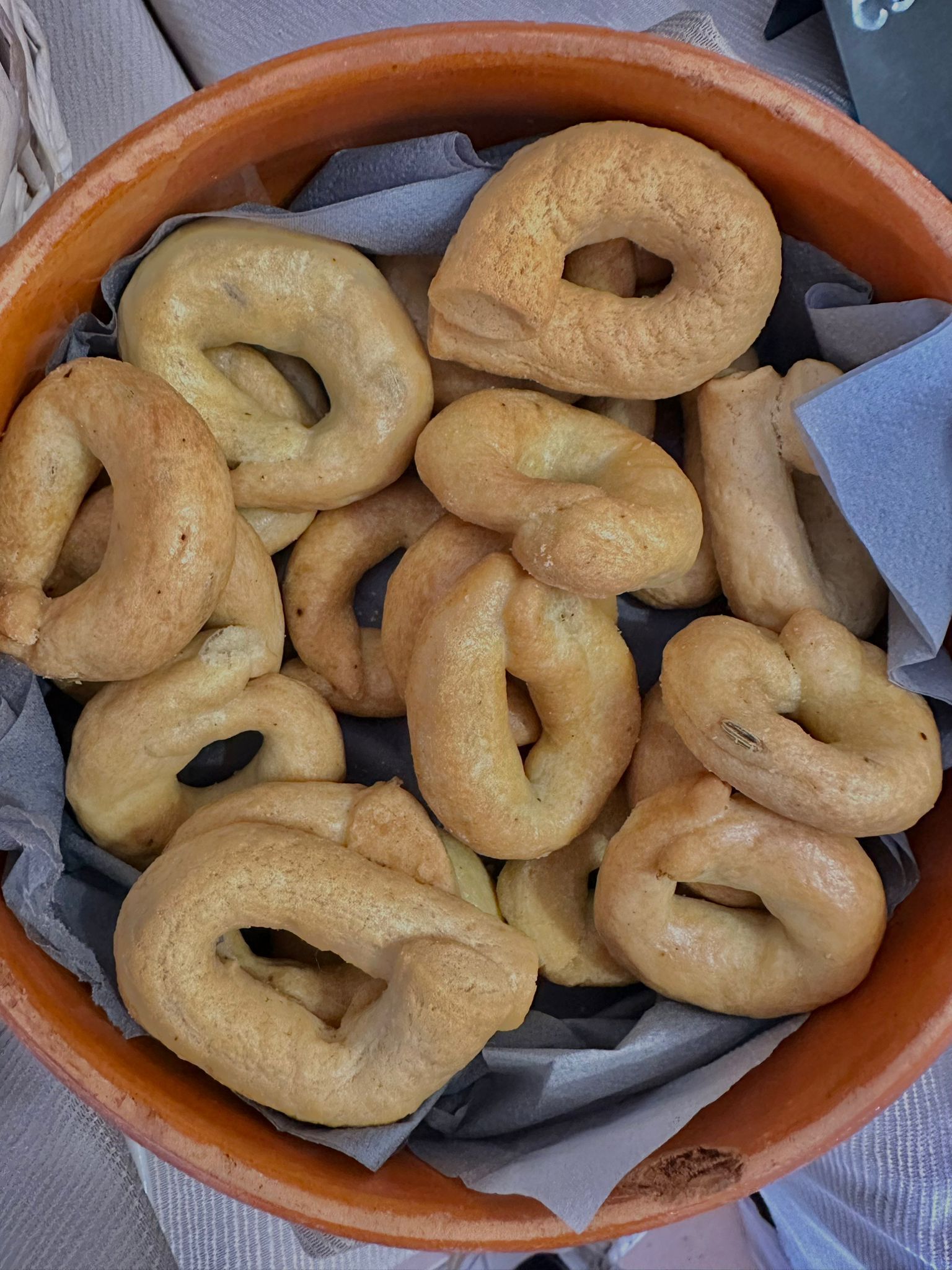 A basket filled with pretzel-shaped bread.