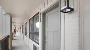 A corridor with a white door marked '207', a window, and a light fixture. - 207 Walk to Convention Center and The Landing (Branson)