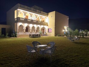 A building with a courtyard, outdoor seating, and traditional architectural elements. - Braham Niwas Resort (Pushkar)