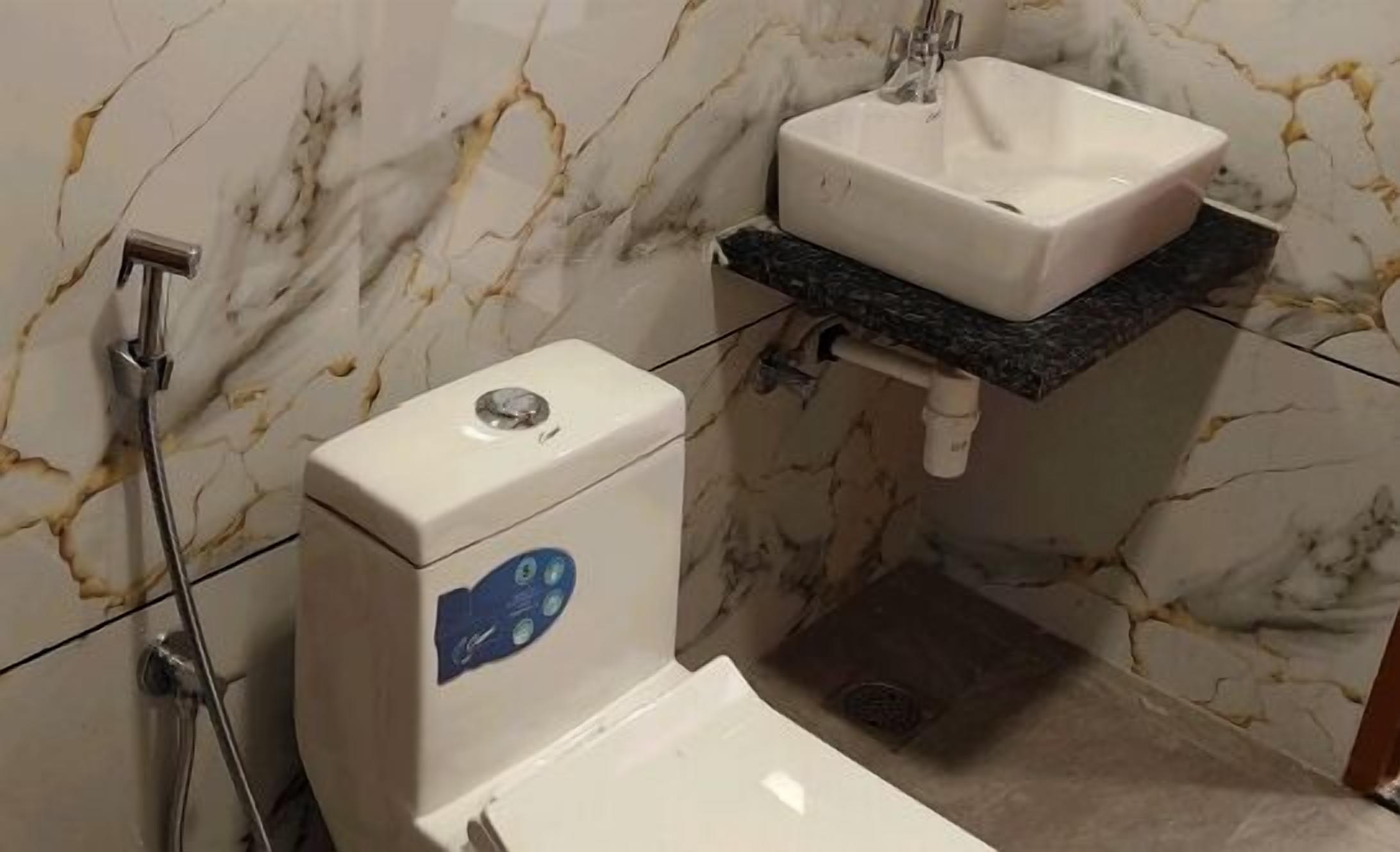 A bathroom with a toilet, a sink, and a shower.