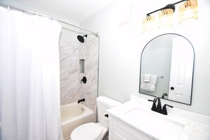 A modern bathroom with a shower, toilet, and sink. - Casa Del Sol 648 3 Bedroom Townhouse (Ocean City)