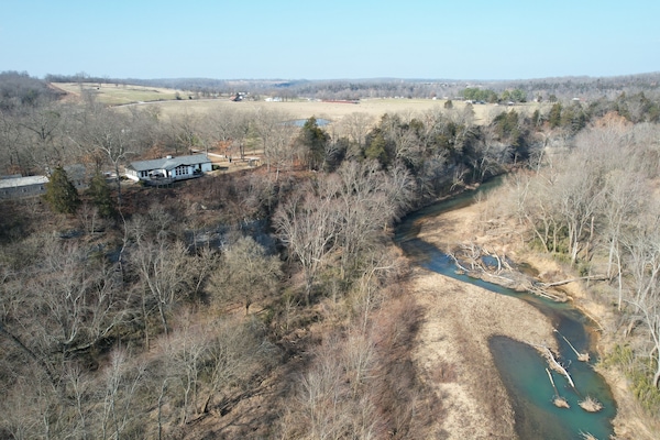 Our house situated above the War Eagle Creek. Guest house to the left.