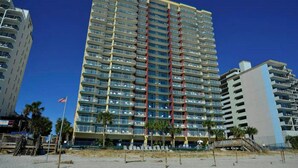 A tall, multi-story hotel with balconies, located near a beach. - Grand Atlantic 1407- Oceanfront - Indoor/Outdoor Pools (Myrtle Beach)