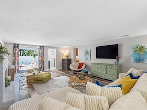 The living opens to the lovely pool area - Heated Pool Home Near Theme Parks | 3BR, Sleeps 7, Fenced Yard, Shops Across the Street (Lakeland)