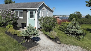 A house with a satellite dish, a door, and a view of a body of water. - Ocean view house (Overton)