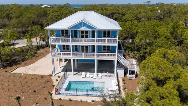 A two-story beachfront house with a pool, surrounded by pine trees. - Ocean View, Modern, Elegant Oasis With Private Pool In Gated, Coastal Community! (Eastpoint)