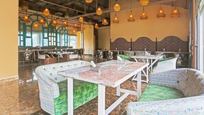 A restaurant with booths, hanging wicker lamps, and a view of the outdoors. - Stylish Room With Mesmerizing View Dharamshala (Dharamshala)