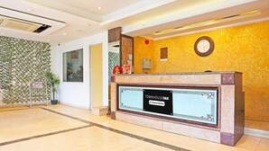A reception desk with a sign reading "Townhouse Oak Company Serviced." - Stylish Room With Mesmerizing View Dharamshala (Dharamshala)