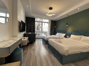 A modern hotel room with a large bed, a desk, and a view of the outdoors. - Onyx Pyramids Boutique Hotel (Giza)