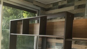 A bunk bed with a wooden frame and a mattress, set against a wall with a striped pattern. - Spacious family home on the Arcachon basin (La Teste-de-Buch)
