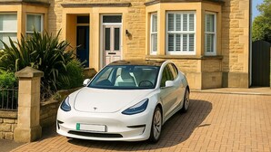 A two-story house with a stone facade, a bay window, and a parked white car in front. - Stunning 5 bed house in enviable location (Bath)