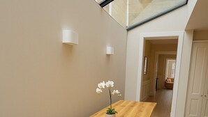 A wooden dining table with a bench, a potted orchid, and a staircase in the background. - Stunning 5 bed house in enviable location (Bath)