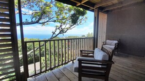 A wooden deck with a view of the ocean and trees. - Cannelle, Sea View, shared pool Mont Vert Les Bas (Montvert)
