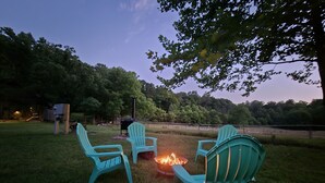 An outdoor seating area with chairs and a fire pit.