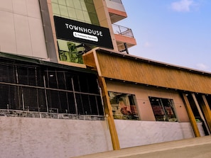 A building with a sign reading 'TOWNHOUSE' and a company-serviced label.