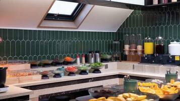 A kitchen with a skylight, a variety of food items, and kitchen appliances.