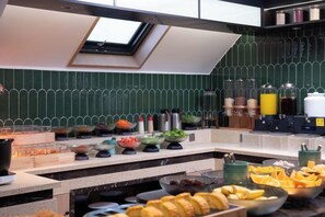 Een keuken met een dakraam, diverse etenswaren en keukenapparatuur.