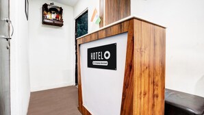 A reception desk with a sign reading "HOTEL 6 Company: Serviced".