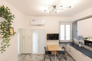 Enjoy meals in this kitchen with a stove and oven, flat-screen TV, and dining area.