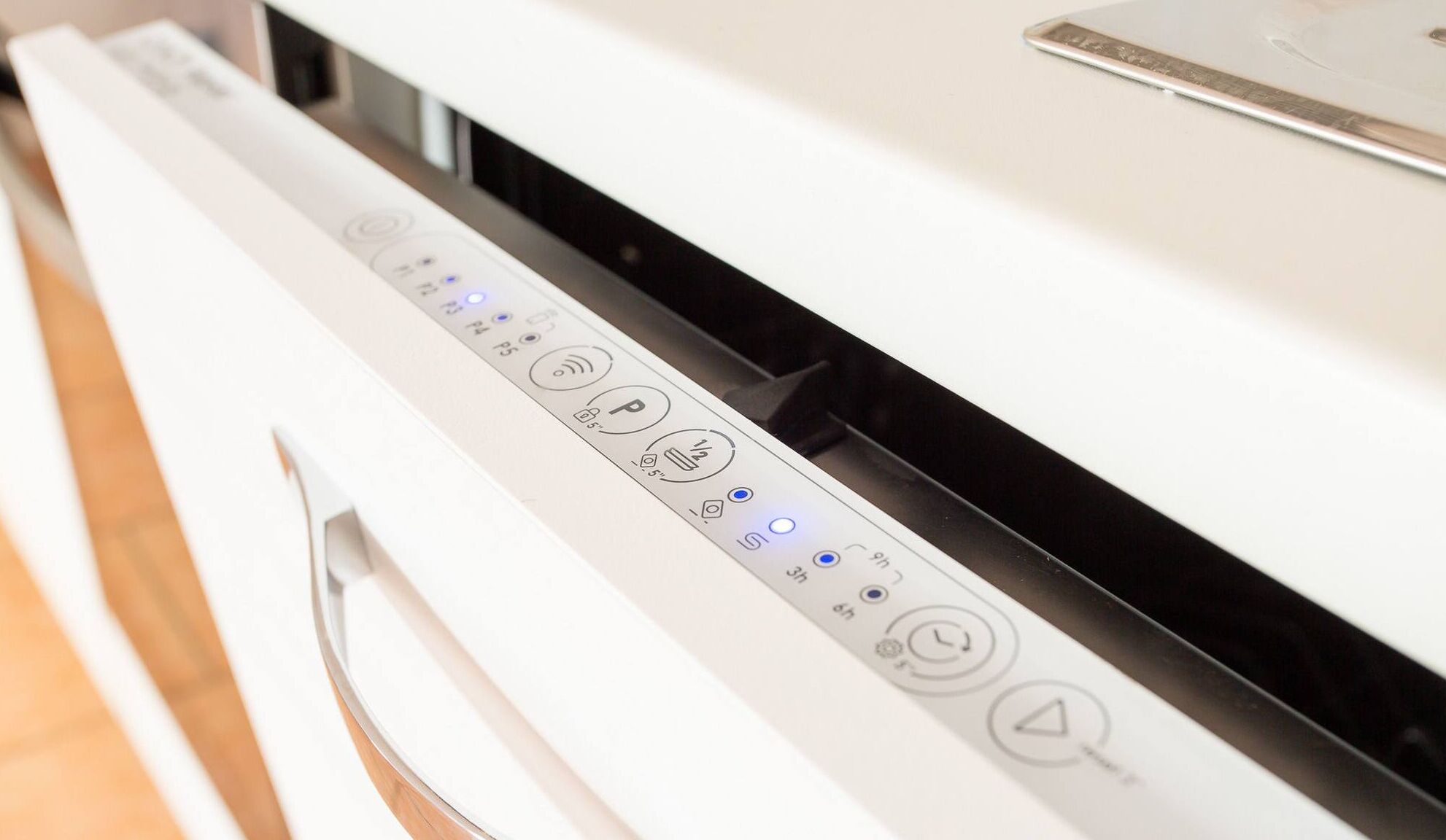 A white appliance with a control panel featuring various buttons and indicators.