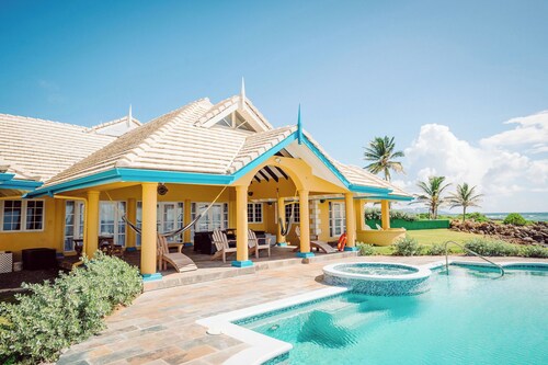 Ocean front luxury villa in gated golf course community with private beach.