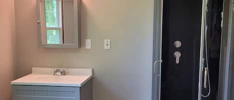 Shower, hair dryer, towels, soap