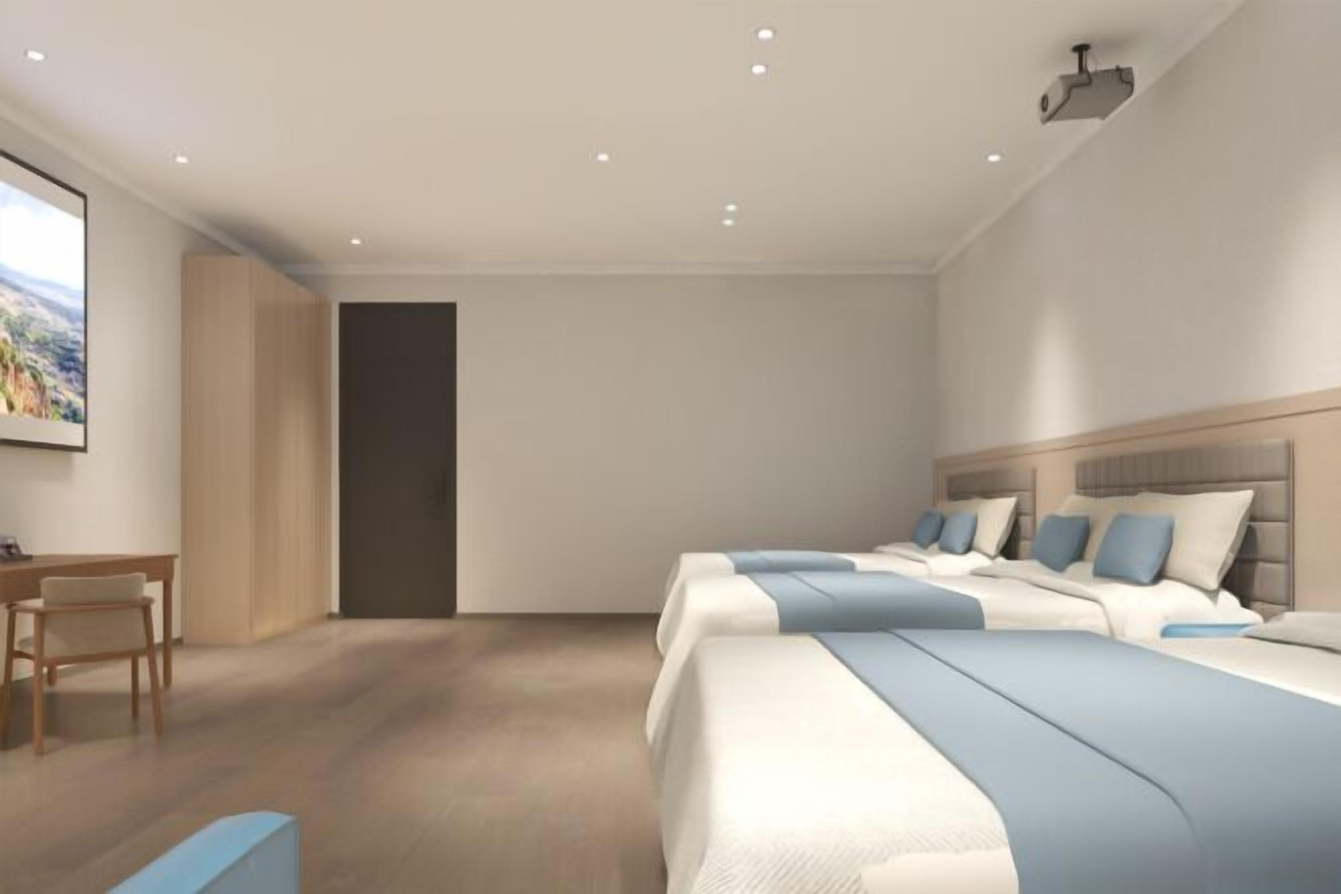 A modern hotel room with a large bed, a desk, and a chair.