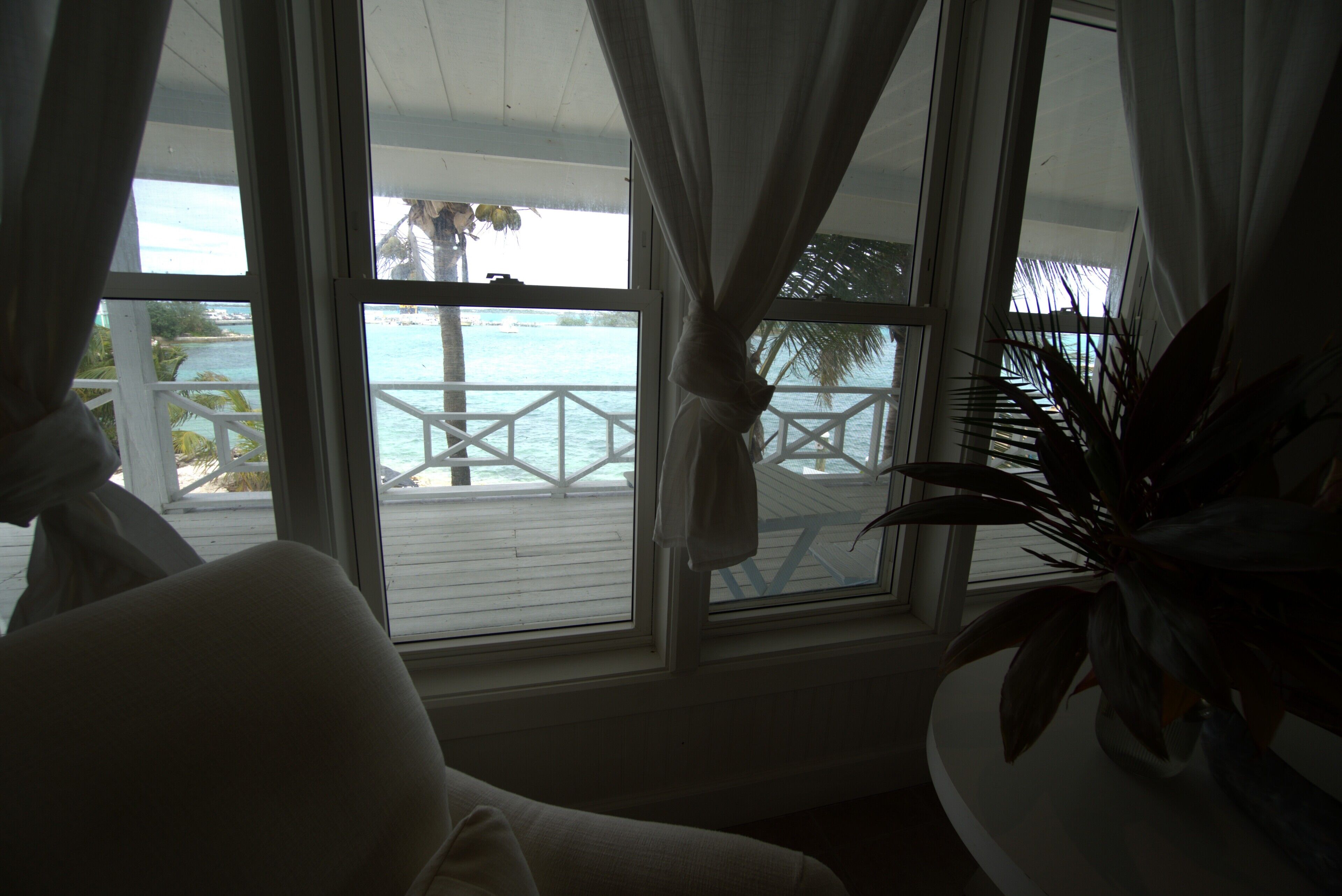 A room with a view of a beach and a balcony.