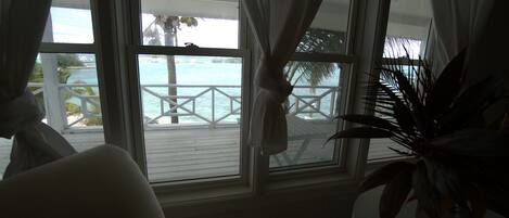 A room with a view of a beach and a balcony.