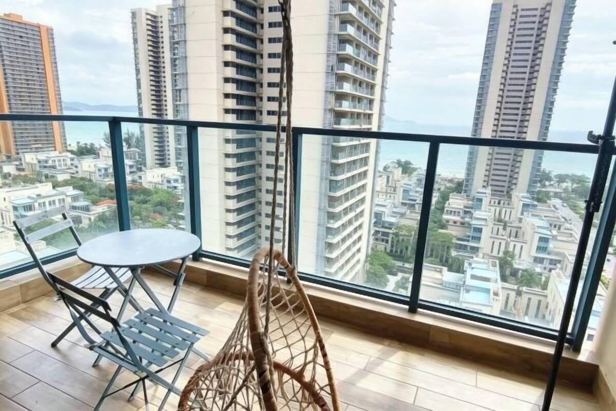 A balcony with a view of high-rise buildings and a cityscape.