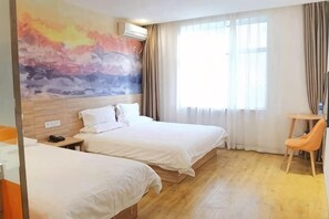 Una habitación de hotel con dos camas, un escritorio y una silla.