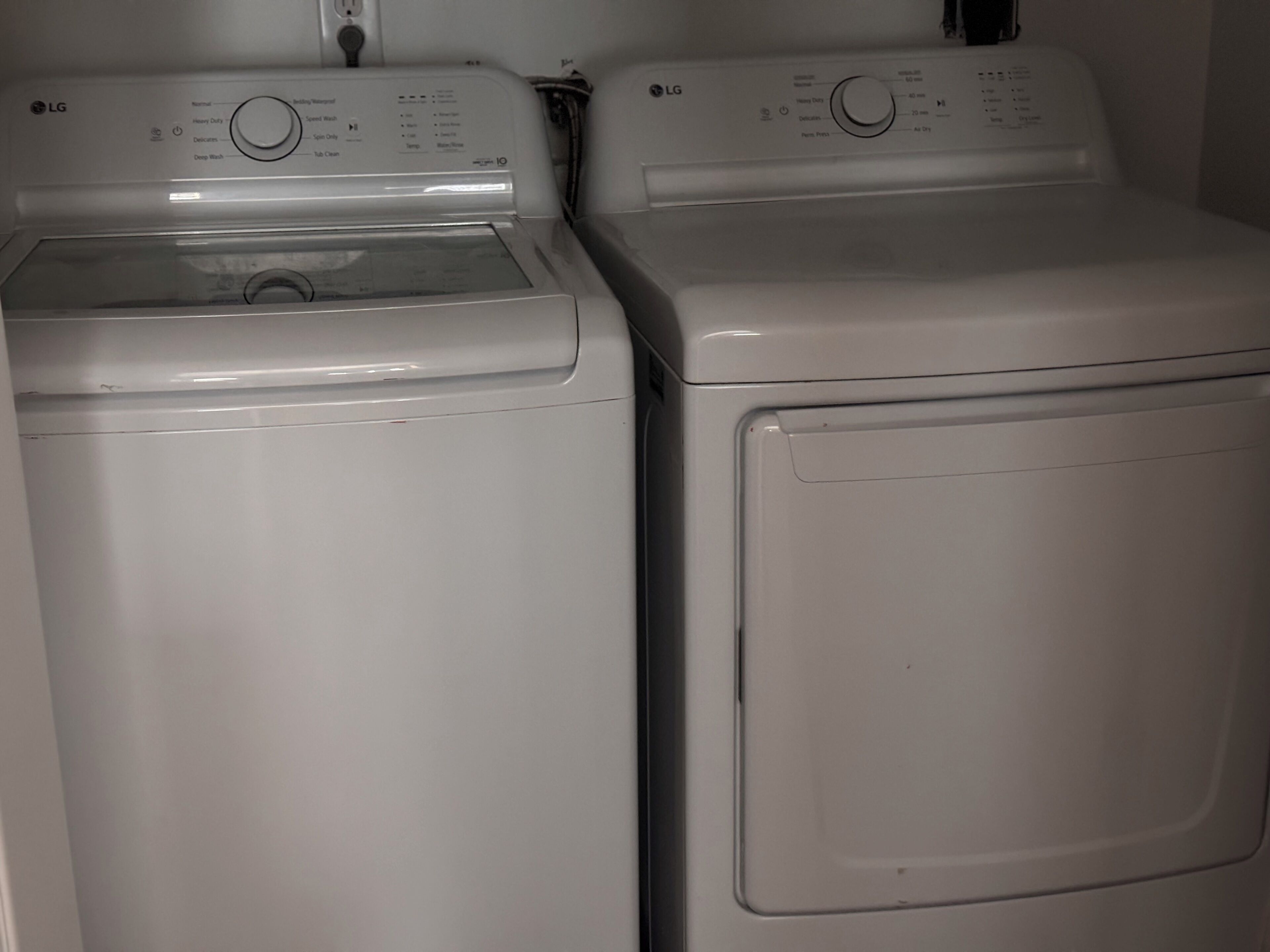 Dos lavadoras LG blancas de carga frontal, una al lado de la otra.