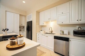 A modern kitchen with white cabinetry, a stainless steel dishwasher, and a built-in oven. - Bella Vista 7E, 3Bdr/3.5 Bth Condo (Playa Herradura)