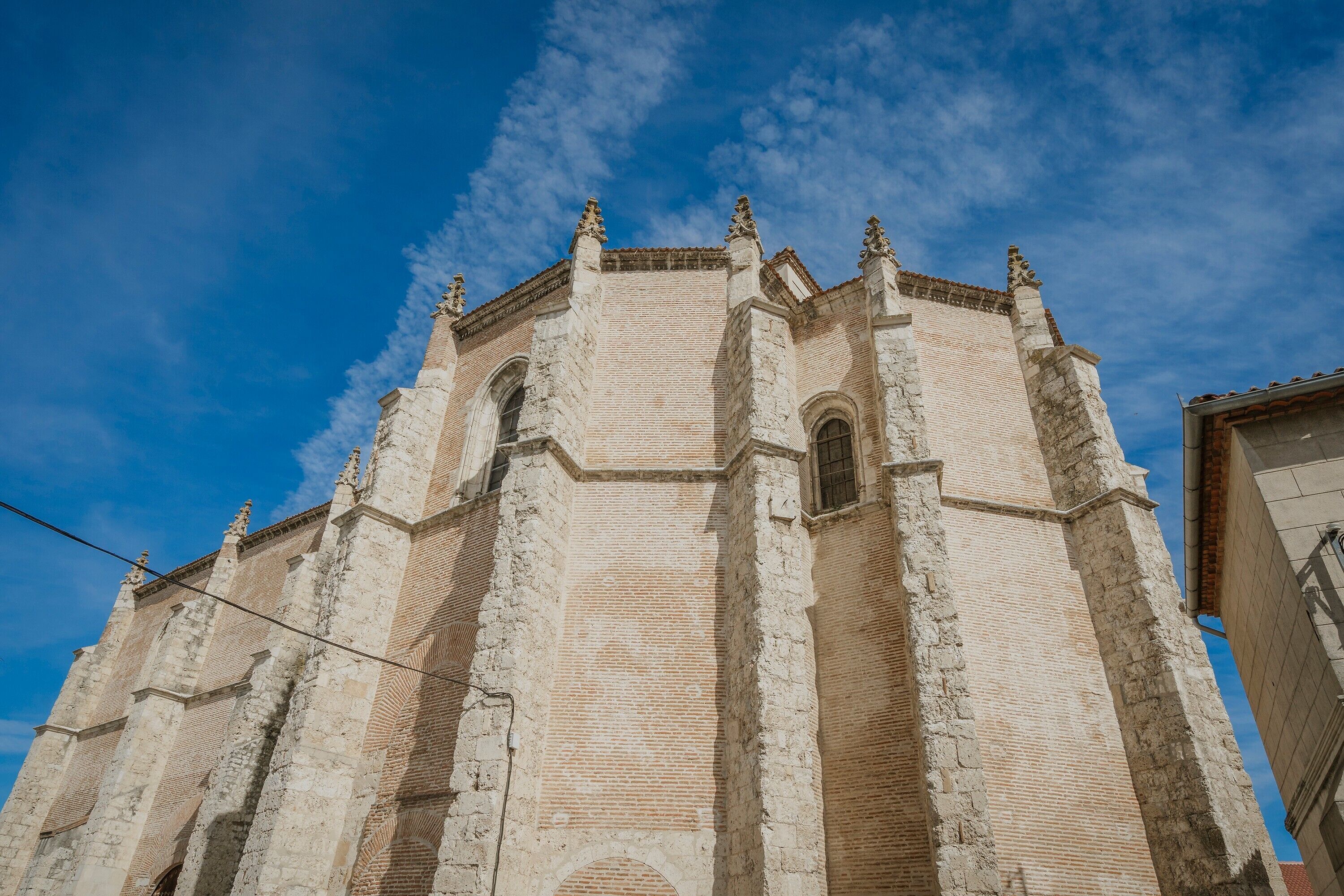 A historic building with a prominent central tower and arched windows.