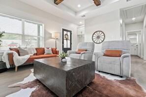 Relax in this stylish living room with a sofa, armchairs, and a coffee table.